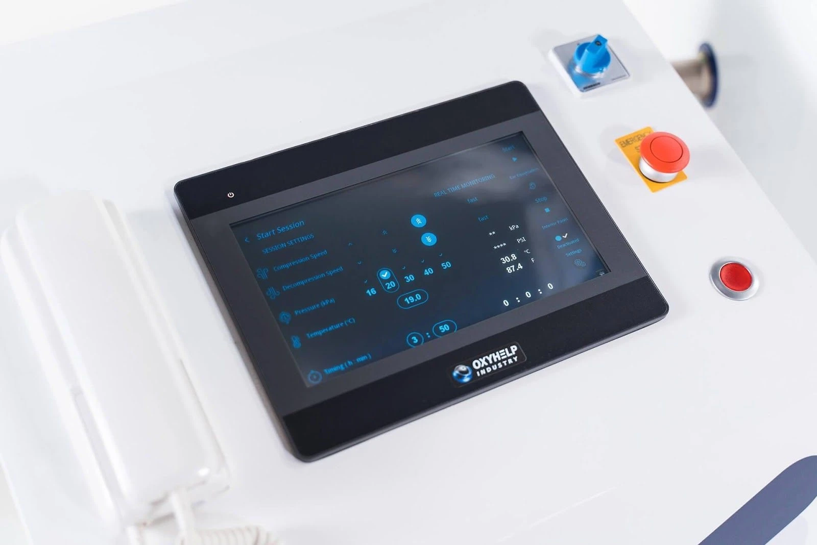 Close-up of a modern touchscreen control panel of an OxyHelp system, displaying various parameters such as air, oxygen speed, pressure, temperature, and humidity, with adjustment options and emergency buttons, suggesting a high-tech, precision device for medical or industrial applications.